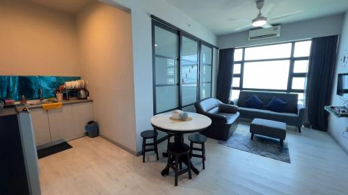 a small living room with a table and a couch at Quennie homestay in Kota Kinabalu