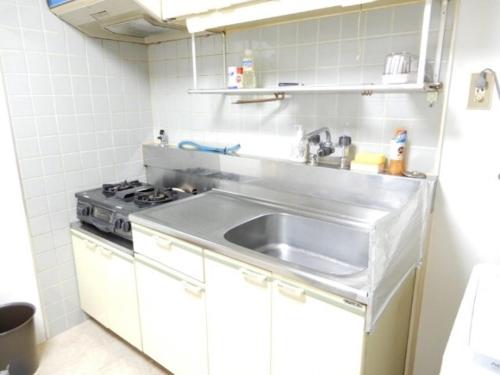a small kitchen with a sink and a stove at Ueda Building - Vacation STAY 8557 in Asahikawa