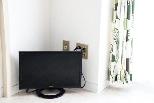 a flat screen tv in a corner of a room at Ueda Building - Vacation STAY 8555 in Asahikawa