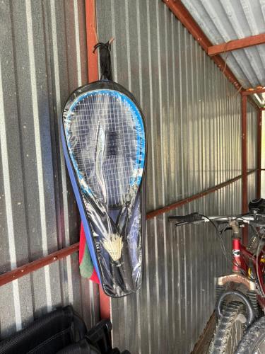 a tennis racket is hanging on a wall at Domek pod lasem in Kańczuga
