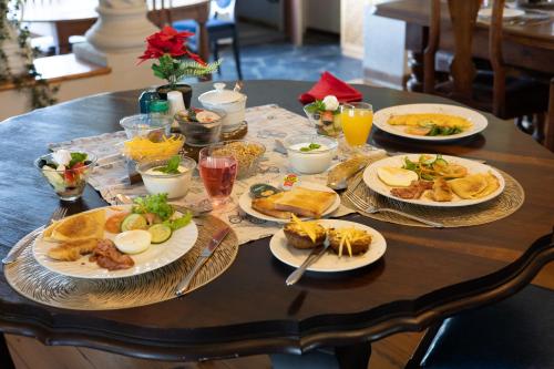 a table with plates of food on it at Homestead Bed and Breakfast in Addo