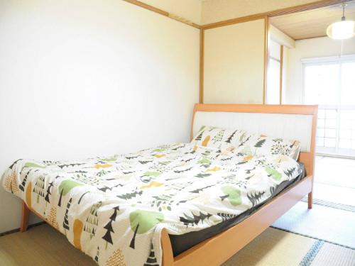 a bedroom with a bed in a room at Ueda Building - Vacation STAY 8563 in Asahikawa