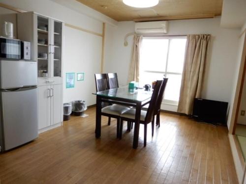 a kitchen with a table and chairs and a window at Ueda Building - Vacation STAY 8562 in Asahikawa