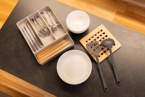 a table with white plates and utensils on it at winco - Vacation STAY 06660v in Tokyo