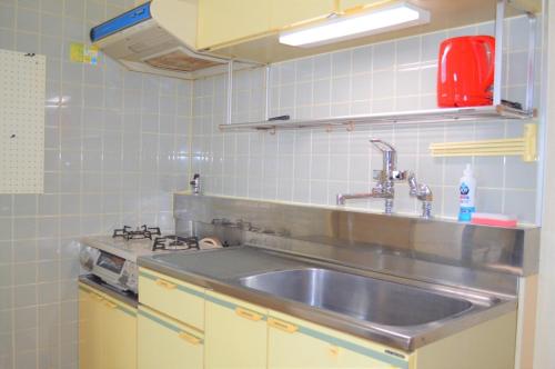 a kitchen with a sink and a stove at Ueda Building - Vacation STAY 8566 in Asahikawa