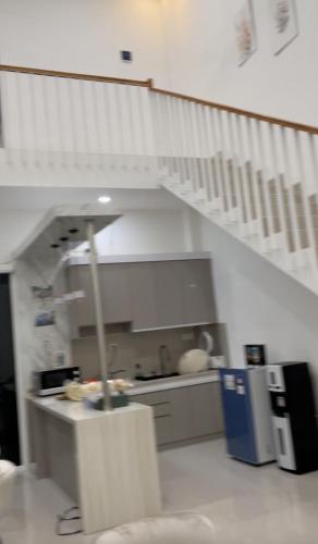 a kitchen with a staircase and a counter in a room at D'illy Borobudur Villa in Magelang