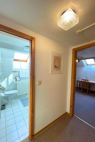 a room with a bathroom with a shower and a glass door at SB-"PENSION Berggasse" - Gemeinschaftsküche, WIFI, Smart-TV, Zentral! in Olbernhau