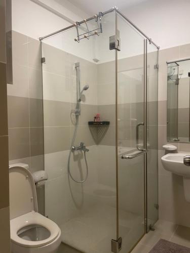 a bathroom with a shower with a toilet and a sink at Beach Front Apartment 1 in Bopitiya