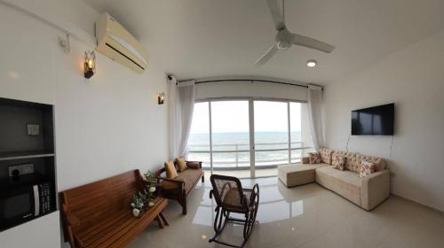 a living room with a view of the ocean at Beach Front Apartment 1 in Bopitiya