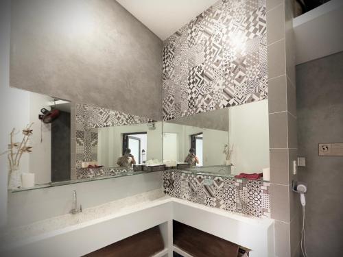 a bathroom with a large mirror on the wall at Lacasa Homestay in Hue