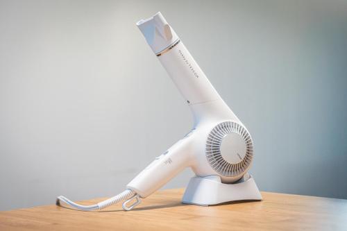 a white hair dryer sitting on top of a table at HANABI棟-BASE棟 サウナ BBQ 農業体験 花火 が楽しめる ペット可 貸し切りで最大12名宿泊可能 Wi-Fi完備 in Katori