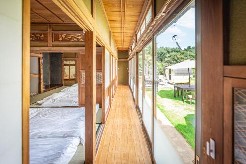 a room with two beds and a sliding glass door at HANABI棟-BASE棟 サウナ BBQ 農業体験 花火 が楽しめる ペット可 貸し切りで最大12名宿泊可能 Wi-Fi完備 in Katori