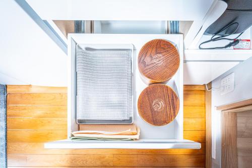 an open refrigerator with a window and plates at HANABI棟-BASE棟 サウナ BBQ 農業体験 花火 が楽しめる ペット可 貸し切りで最大12名宿泊可能 Wi-Fi完備 in Katori