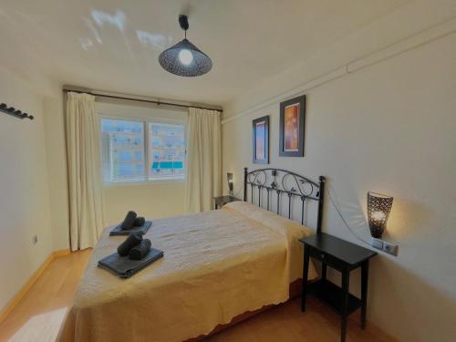 a bedroom with a large bed and a window at Apartamentos Terrasol BARCO 5 in Torre del Mar
