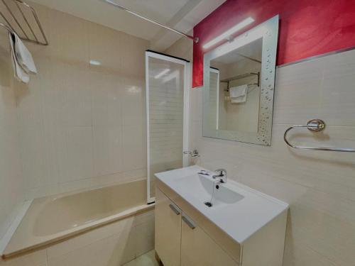 a bathroom with a sink and a tub and a mirror at Apartamentos Terrasol BARCO 5 in Torre del Mar