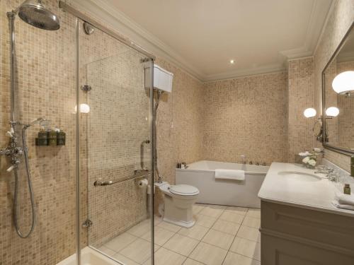 a bathroom with a shower and a toilet and a sink at Lough Erne Resort in Enniskillen