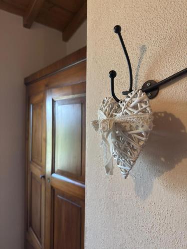 a heart shaped umbrella hanging on a wall at Agriturismo Il Filare in Neviano degli Arduini