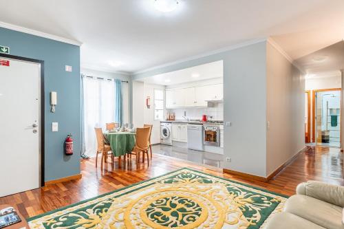 a kitchen and living room with a table and chairs at Lobos Village in Câmara de Lobos