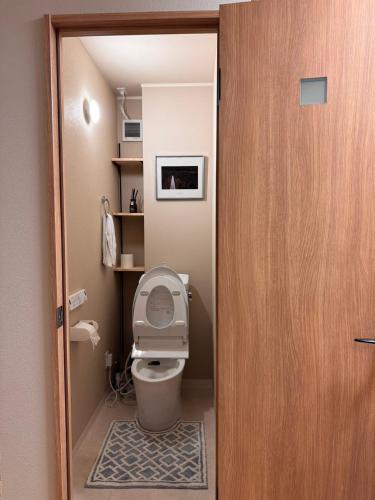 a bathroom with a toilet with the lid up at Cozy House Namba in Osaka