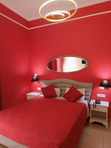 a red bedroom with a bed with a red wall at Exis Hotel in Athens