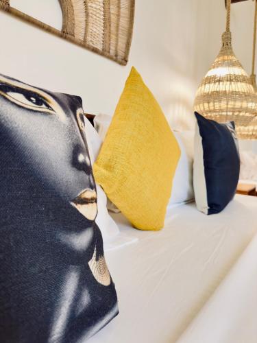 a bed with four pillows on it with at Olzadia Boutique Hotel in Michamvi