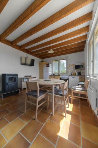 a kitchen with a table and chairs in a room at Le Berylune - Maison 2 chambres - Campagne in Abrest