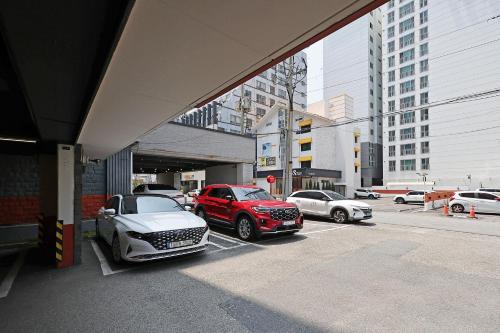 a group of cars parked in a parking lot at Hotel Gem in Busan