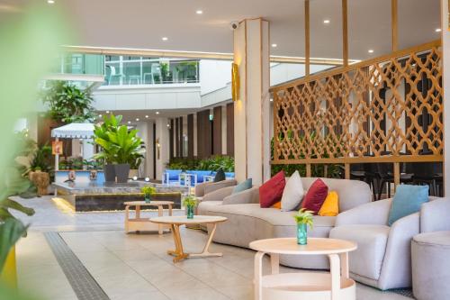 a lobby with couches and tables in a building at Chalong Marina Bay View Rawai Phuket in Rawai Beach
