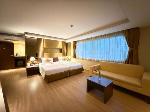 Nova Gold Hotel Pattayaにあるベッド