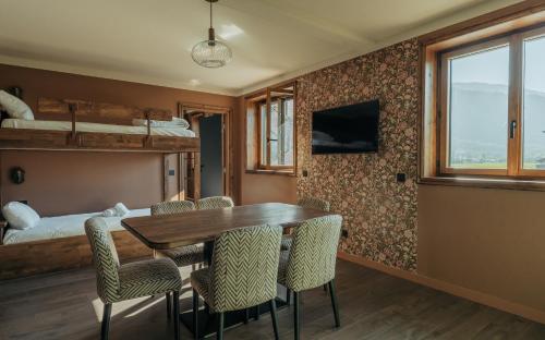a dining room with a table and chairs and a bed at La Tour de Contrôle - Chambres & Appartements in Challes-les-Eaux