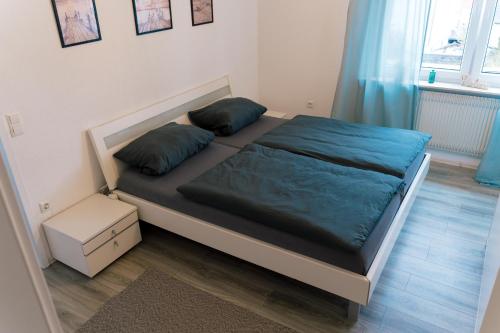 un letto in una camera da letto con cuscini blu di FeriendomizilaufderZollernalb ad Albstadt