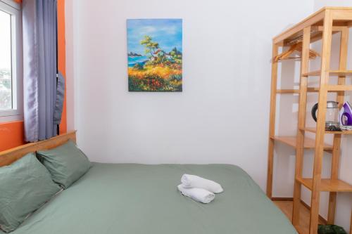 a bedroom with a bed and a book shelf at D Home Da Lat 3 in Da Lat