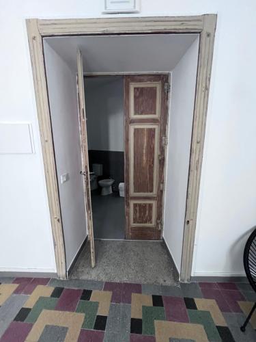 an open door in a room with a toilet at Residenza Margot Cosenza in Cosenza