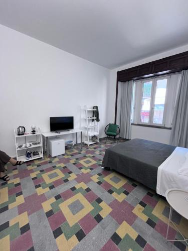a bedroom with a bed and a colorful carpet at Residenza Margot Cosenza in Cosenza