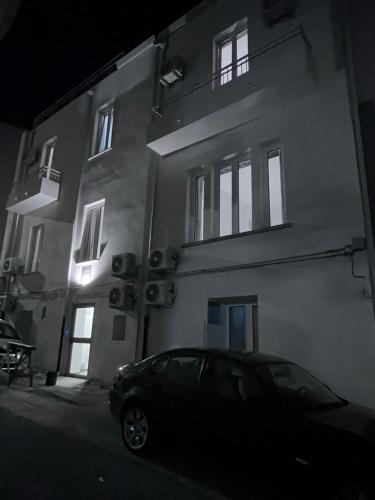 a car parked in front of a building at night at Residenza Margot Cosenza in Cosenza