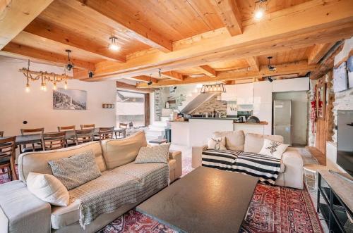 a living room with a couch and a table at Ferme Saint-Aubin in Sainte-Foy-Tarentaise