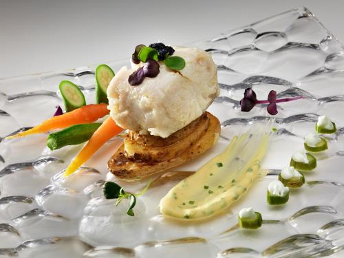 a plate of food with carrots and vegetables on it at Melia Jardines del Teide - Adults Only in Adeje