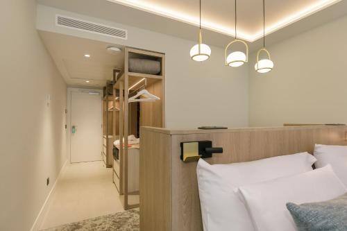 a bedroom with a bed with white pillows at Sol Torremolinos - Don Pablo in Torremolinos