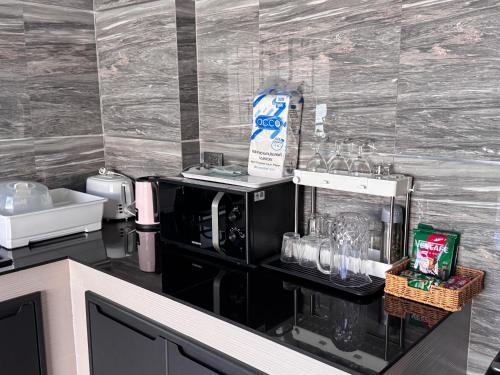a kitchen with a counter with a coffee maker at Jmpoolvilla in Nakhon Si Thammarat