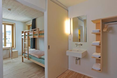 a bathroom with a bunk bed and a sink at St. Moritz Youth Hostel in St. Moritz