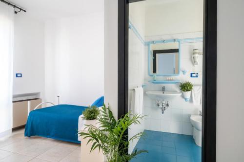 a bathroom with a toilet and a sink at Sympathy Hotel in Martinsicuro