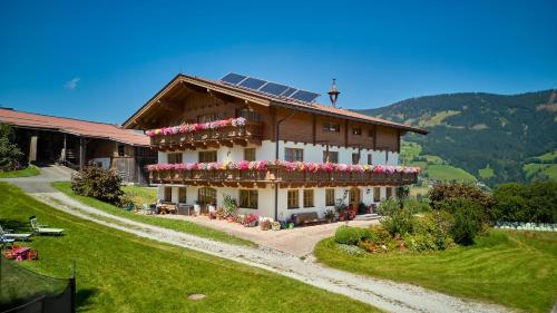 a house with a solar roof with flowers on it at Sauschneid Hof in Taxenbach