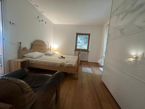 a bedroom with a bed and a couch at Massone Climbing House - Holiday Home Garda Trentino in Arco
