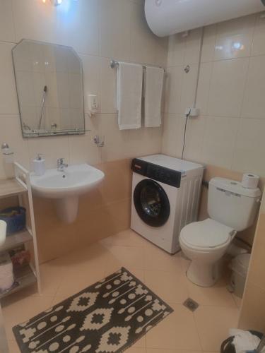 a bathroom with a toilet and a sink at Аpartments Comfort -Marina Cape in Aheloy