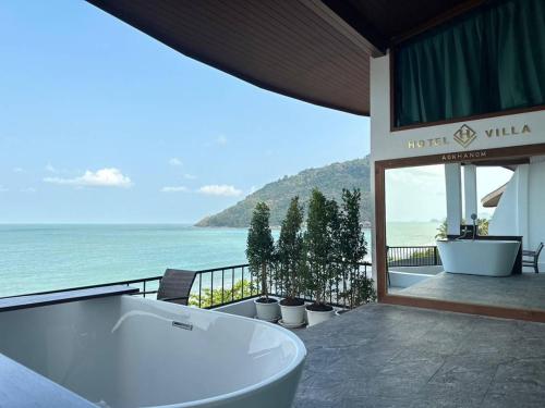 a bath tub sitting outside of a hotel with the ocean at Hotel Villa AoKhanom Beachfront in Khanom