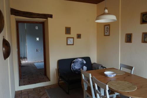 a dining room with a table and a chair at Casas Das Flores in Lajes das Flores