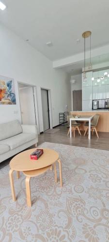 a living room with a table and a couch at Damai Antara Homestay in Putrajaya