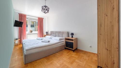 a bedroom with a bed and a dresser in it at Leśna II, Sun & Snow in Hel