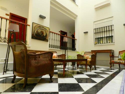 a living room with a black and white checkered floor at Hotel Doña Blanca in Seville