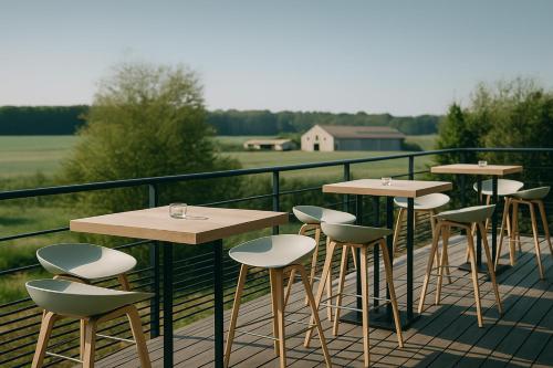 a row of tables and chairs on a balcony at OFF in Wavre